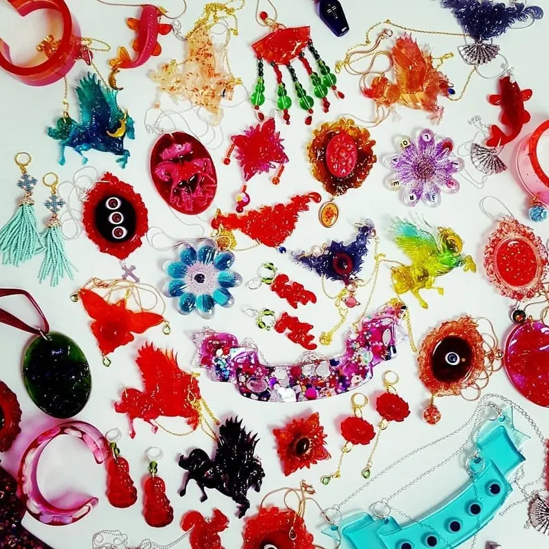 Resin jewellery laid out on white